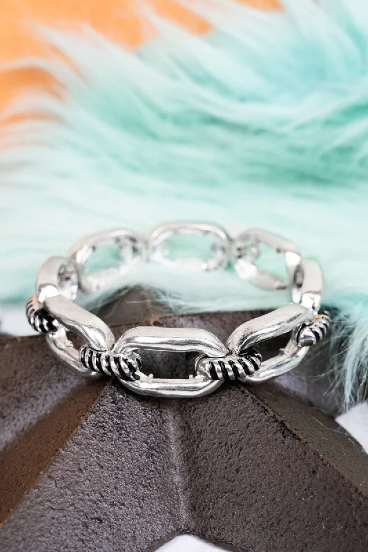 Bangles with sleek matte finish for subtlety -TIPI Let's Get Together Silvertone Stretch Bracelet