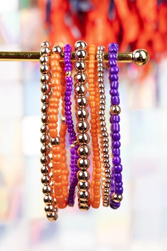 Rose gold bangles with geometric cutout designs -Expect Victory Orange and Purple Beaded Bracelet Set